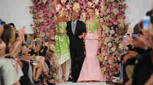 Designer Oscar de la Renta takes a bow with models Karlie Kloss (left) and Daria Strokous after his Spring 2015 collection was modeled Sept. 9 during Fashion Week in New York. De la Renta died on Oct. 20.