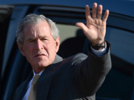Former U.S. President George W. Bush salutes upon arrival at the airport of Gaborone on July 5, 2012. Bush was in Botswana as part of a cervical and breast cancer awareness campaign. (credit: Monirul Bhuiyan/AFP/GettyImages)