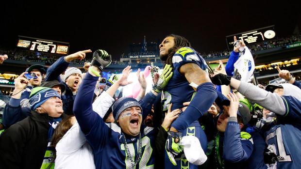 Cornerback Richard Sherman #25 of the Seattle Seahawks celebrates with fans after the Seahawks defeat the San Francisco 49ers 23-17 in the 2014 NFC Championship at CenturyLink Field on January 19, 2014 in Seattle, Washington.  (Photo by Jonathan Ferrey/Getty Images)