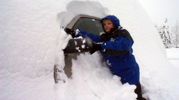 CBS4's Suzanne McCarroll tries to clear snow off a vehicle.