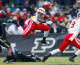 WEST LAFAYETTE, IN - NOVEMBER 8: Melvin Gordon #25 of the Wisconsin Badgers leaps over Leroy Clark #3 of the Purdue Boilermakers during the game at Ross-Ade Stadium on November 8, 2014 in West Lafayette, Indiana. Wisconsin defeated Purdue 34-16. (Photo by Michael Hickey/Getty Images)