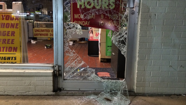 While some in Ferguson looted late Friday night into Saturday morning, others tried to protect local businesses from damage. (Credit: Michael Calhoun, KMOX)
