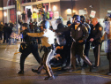 FERGUSON, MO - OCTOBER 22:  Police face off with demonstrators outside the police station as protests continue in the wake of 18-year-old Michael Brown's death on October 22, 2014 in Ferguson, Missouri. Several days of civil unrest followed the August 9 shooting death of Brown by Ferguson police officer Darren Wilson. Today's protest was scheduled to coincide with a day of action planned to take place nationwide to draw attention to police brutality.  (Photo by Scott Olson/Getty Images)