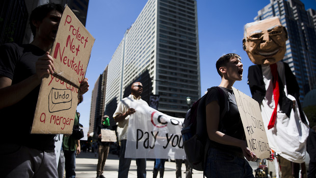Protesters demonstrate across the street from the Comcast Center on Sept. 15, 2014, in Philadelphia.