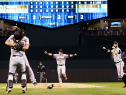 Buster Posey #28 and Madison Bumgarner #40 of the San Francisco Giants celebrate after defeating the Kansas City Royals to win Game 7 of the 2014 World Series by a score of 3-2 at Kauffman Stadium on October 29, 2014 in Kansas City, Missouri. (Photo by Jamie Squire/Getty Images)