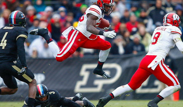 WEST LAFAYETTE, IN - NOVEMBER 8: Melvin Gordon #25 of the Wisconsin Badgers leaps over Leroy Clark #3 of the Purdue Boilermakers during the game at Ross-Ade Stadium on November 8, 2014 in West Lafayette, Indiana. Wisconsin defeated Purdue 34-16. (Photo by Michael Hickey/Getty Images)