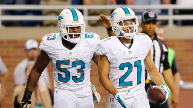 DETROIT, MI - NOVEMBER 09: Brent Grimes #21 celebrates a second quarter interception with Jelani Jenkins #53 of the Miami Dolphins while playing the Detroit Lionsat Ford Field on November 09 , 2014 in Detroit, Michigan. (Photo by Leon Halip/Getty Images)