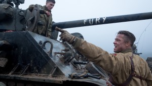 Brad Pitt (foreground) instructs Logan Lerman about operating the tank called Fury.