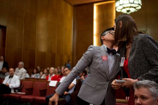 Melanie Pang, left, kisses her partner, Kendall Toarmina, after Pang voices her support for the equal rights ordinance. Photo: Marie D. De Jesus, Houston Chronicle / © 2014 Houston Chronicle