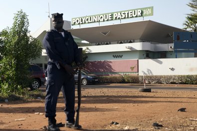 A police officer on guard outside the Pasteur Clinic in Bamako, Mali, where a patient with the country's second confirmed case of Ebola died.
