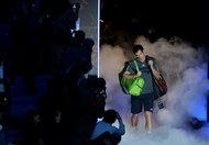 Andy Murray walked through dry ice before his match Tuesday against Milos Raonic at the ATP World Tour Finals. Murray won, 6-3, 7-5.