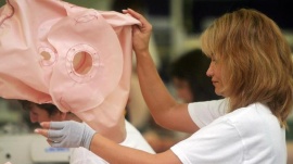 A woman arranges airbag cushions at a plant for Japanese car parts maker Takata Corp. in Sibiu, 280km (175 miles) northwest of Bucharest, in this September 4, 2006 file photo. REUTERS/Mihai Barbu 