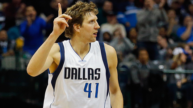 Dirk Nowitzki of the Dallas Mavericks celebrates after scoring against Carl Landry of the Sacramento Kings to take 9th place on the NBA's All-Time Scoring list in front of Hakeem Olajuwon against the Sacramento Kings on November 11, 2014 at the American Airlines Center in Dallas, Texas. (credit: Tom Pennington/Getty Images)