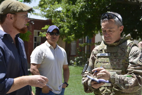 Lt. Col. James Gleason Bishop, right, interviewing the project manager of a non-government organization in Kabul in July.