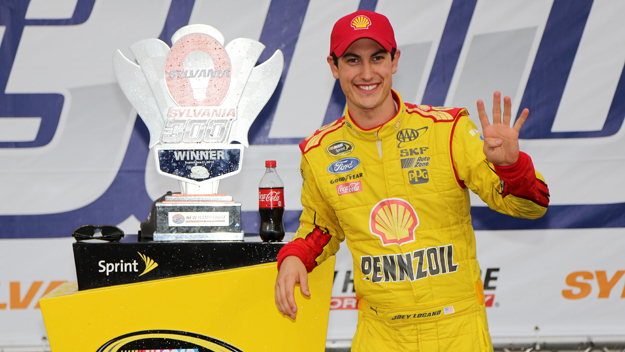 Joey Logano, driver of the #22 Shell-Pennzoil Ford, celebrates in victory lane after winning the NASCAR Sprint Cup Series Sylvania 300 at New Hampshire Motor Speedway on September 21, 2014 in Loudon, New Hampshire. (credit: Jerry Markland/Getty Images)
