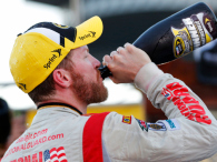 Dale Earnhardt Jr., driver of the #88 National Guard Chevrolet, celebrates in Victory Lane with champagne after winning during the NASCAR Sprint Cup Series Goody's Headache Relief Shot 500 at Martinsville Speedway on October 26, 2014 in Martinsville, Virginia. (credit: Chris Trotman/Getty Images)