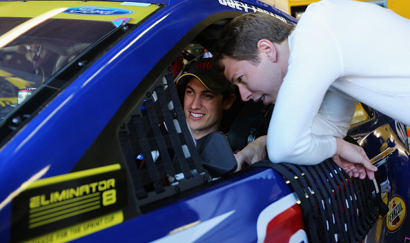 Brad Keselowski, driver of the #2 Miller Lite Ford, talks to Joey Logano (Photo by Jerry Markland/Getty Images for Texas Motor Speedway)