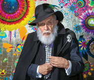 James Randi in front of a painting done by his partner, the artist José Alvarez.