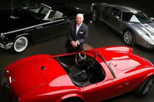 Sam Pack with three cars from three different decades that will be up for auction Saturday.
