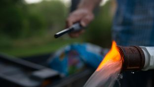 Steve Lipsky shows the methane contamination of his well by igniting the gas with a lighter outside his family's home in Parker County near Weatherford on June 17.