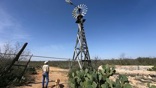 Hugh Fitzsimons surveys the old windmill that pumps at two gallons a minute to fill the pila that then feeds the water trough for his bison and wildlife at SHAPE Ranch in Carrizo Springs, TX, February, 21, 2013.