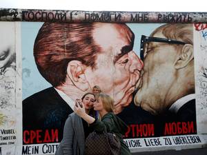 A painting depicting former Soviet leader Leonid Brezhnev kissing his East German counterpart Erich Honecker (R) painted on a segment of the East Side Gallery, the largest remaining part of the former Berlin Wall in Berlin