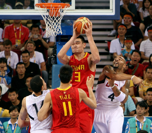Yao Ming, playing for China in the 2008 Summer Olympics,  grabbed a rebound against the United States.