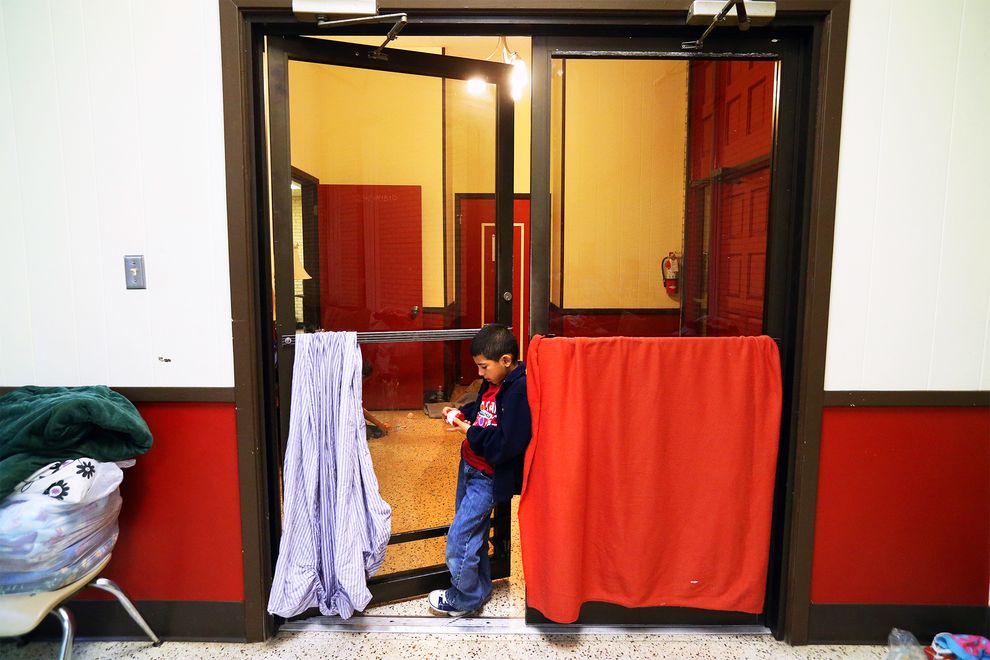 A photo of a little boy at an emergency shelter at the Sacred Heart Catholic Church in McAllen, Tx.