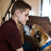 David Heath, 15, of Gilbert, Ariz., with the Heaths’ new dog, Bo, a boxer, at his home. Behind him are tributes to the family’s three dogs that died at Green Acre Dog Boarding in June.