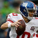 Giants quarterback Eli Manning avoiding the rush in the first quarter, which ended with the score 7-7 after a 6-yard Manning touchdown pass to Preston Parker.