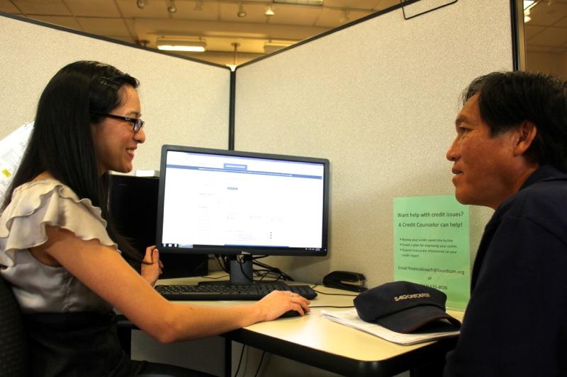 A certified application counselor helps a health insurance consumer at Insure Central Texas in Austin's Highland Mall on Nov. 10, 2014.