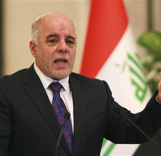 Image: Iraq's Prime Minister-designate Haider al-Abadi gestures during a news conference in Baghdad