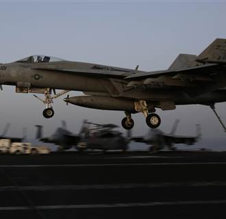 Image: An F/A-18C Hornet coming from Iraq lands on the flight deck of the U.S. Navy aircraft