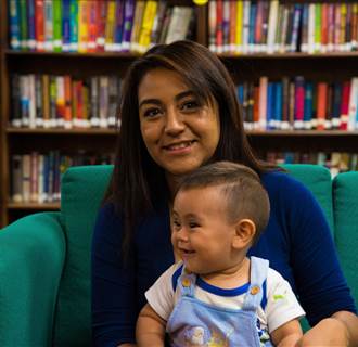 Image: Carina Ramirez holds her son Seth in Los Lunas, New Mexico.