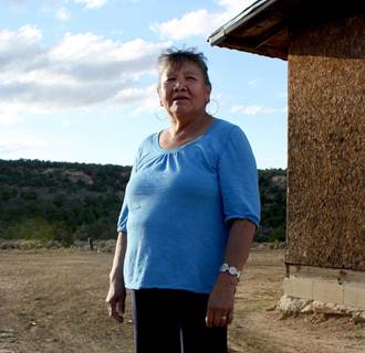Image: Mary Shay stands outside the two-room hut that she shares with her sister on a part of the Navajo Reservation about 9 miles from Gallup, New Mexico, the closest town off the reservation.