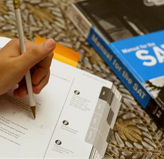 Image: A student uses a Princeton Review SAT Preparation book to study for the test 