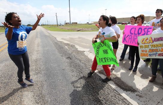 Deborah Alemu (left) encourages protestors to chant during a rally in front of the Karnes County Residential Center in Karnes City on Saturday, Oct. 11, 2014. About 100 protesters rallied near the facility to demand the closing of the center and for the release of immigrants detained at the facility. Photo: Kin Man Hui, San Antonio Express-News / ©2014 San Antonio Express-News
