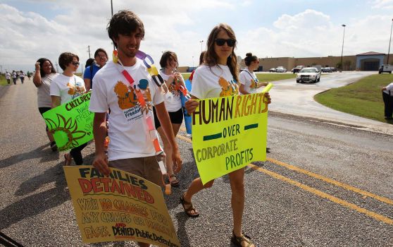 About 100 protesters rally in front of the Karnes County Residential Center near Karnes City demanding the closing of the facility and for the release of immigrants detained at the facility on Saturday, Oct. 11, 2014. Photo: Kin Man Hui, San Antonio Express-News / ©2014 San Antonio Express-News