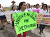 Andrea Ortiz of Austin (center) joins others in a chant for justice for immigrants at the Karnes County Residential Center near Karnes City on Saturday, Oct. 11, 2014. About 100 protesters gathered to demand the closing of the facility and for the release of immigrants detained at the facility.