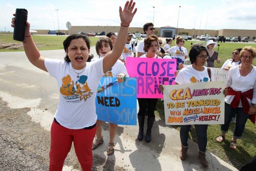 Andrea Ortiz of Austin (left) joins others in a chant for justice for immigrants at the Karnes County Residential Center near Karnes City on Saturday, Oct. 11, 2014. About 100 protesters gathered to demand the closing of the facility and for the release of immigrants detained at the facility. Photo: Kin Man Hui, San Antonio Express-News / ©2014 San Antonio Express-News