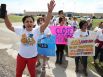 Andrea Ortiz of Austin (left) joins others in a chant for justice for immigrants at the Karnes County Residential Center near Karnes City on Saturday, Oct. 11, 2014. About 100 protesters gathered to demand the closing of the facility and for the release of immigrants detained at the facility.