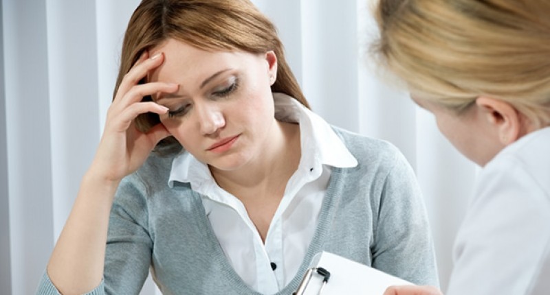 Young woman in a conversation with a consultant (Credit: Shutterstock)