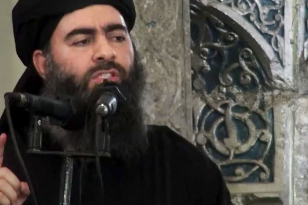 This file image made from video posted on a militant website which has been authenticated based on its contents and other AP reporting, purports to show the leader of the Islamic State group, Abu Bakr al-Baghdadi, delivering a sermon at a mosque in Iraq. 
