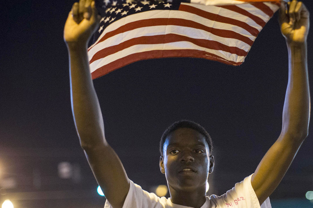 Protester Joshua Wilson marches in front of the police department during a rally in Ferguson, Mo. on Sept. 26, 2014.  (Whitney Curtis/Reuters)