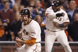 Giants Hunter Pence and Giants Pablo Sandoval celebrate their eighth inning score off a Juan Perez triple during Game 5 of the World Series at AT&T Park on Sunday, Oct. 26, 2014 in San Francisco, Calif.