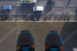 Pedestrians and traffic cross Tower Bridge as viewed through a glass viewing platform on the high-level Walkways during a preview to launch the new viewing experience at the Tower Bridge Exhibition centre in London on November 10, 2014. The new glass flooring at the Tower Bridge Exhibition 42 metres above the river Thames will allow visitors to gaze down on the bridge and river and allow them to experience the bridge opening from above. AFP PHOTO / ANDREW COWIEANDREW COWIE / AFP,ANDREW COWIE/AFP/Getty Images