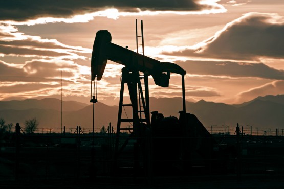 In this Dec. 5, 2012 photo, the sun sets behind an oil pump jack and the Rocky Mountains near Fredrick, Colo. 