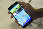 A customer looks at the new Samsung Electronics Co. Galaxy S5 smartphone on display at a Best Buy Co. store in San Francisco, California, U.S., on Friday, April 11, 2014. The S5 features a 5.1-inch screen with a fingerprint reader, 16-megapixel camera, heart-rate sensor, water-resistant coating that can withstand 30 minutes at the bottom of a meter-deep (3-foot deep) pond, and a back resembling dimpled leather. Photographer: David Paul Morris/Bloomberg