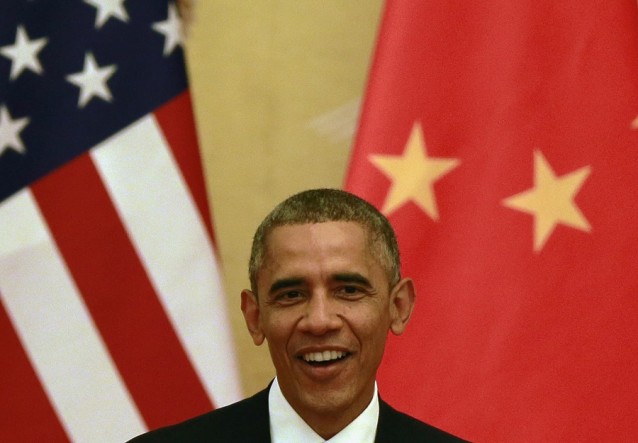 U.S. President Barack Obama smiles while he speaks during a joint press conference with Chinese President Xi Jinping at the Great Hall of the People in Beijing, China Wednesday, Nov. 12, 2014. 