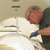 Dr. Steven Birnbaum positions a patient inside a CT scanner at Southern New Hampshire Medical Center in Nashua, N.H., in June 2010.